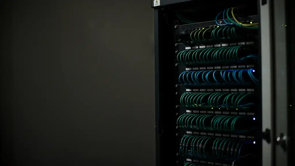 Close detail of computer hardware and cabling lit in cool blue inside a machine.